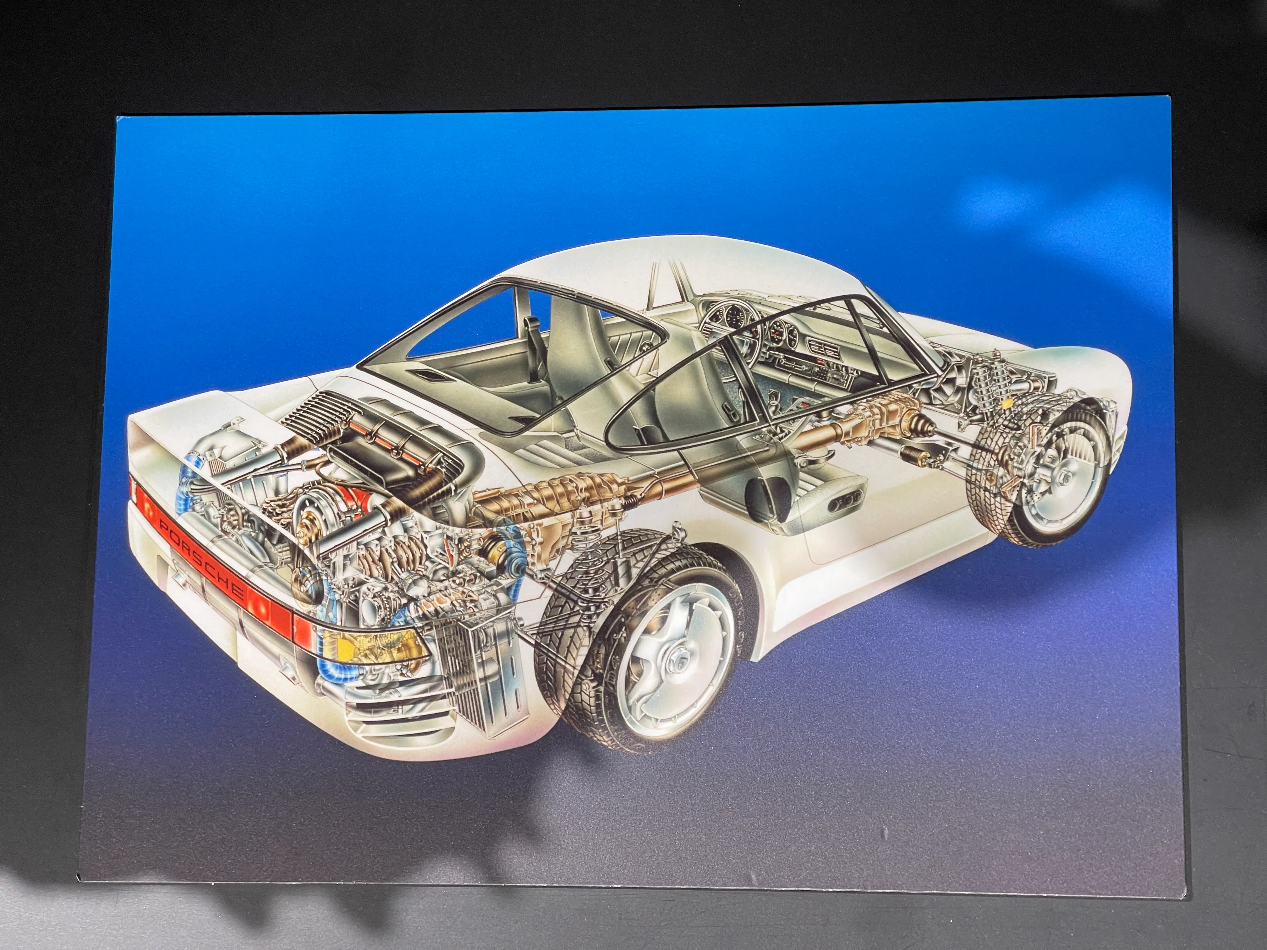 Factory mechanical sketch of the 959 on display at the Porsche Museum in Stuttgart, showing the PSK all-wheel-drive layout and twin-turbo flat-six.