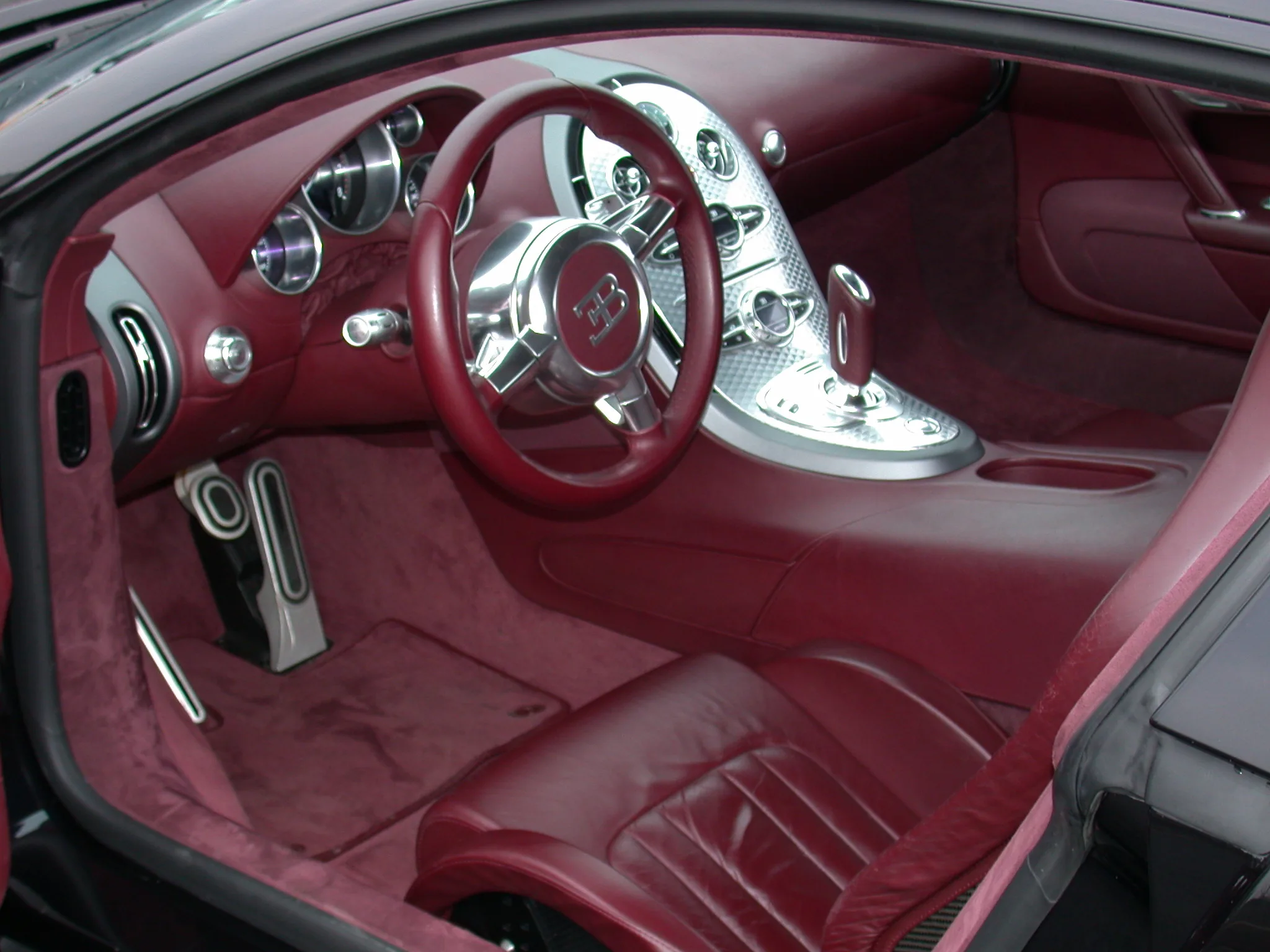 Interior of a 2007 Veyron showing the brushed-aluminum cabin architecture, the interior specification Cropley described as resembling a Swiss watch movement.