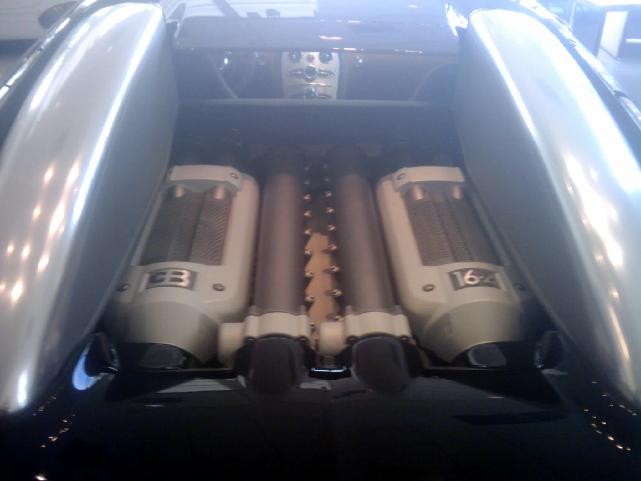 The W16 engine installed on the Veyron chassis, showing the packaging challenge of fitting four turbochargers and ten radiators around the powerplant.